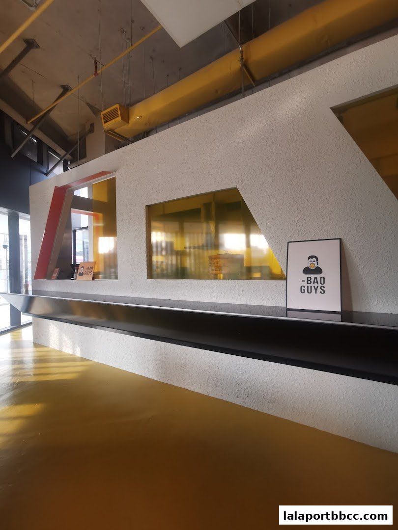The interior counter area of The Bao Guys restaurant with a sign featuring the shop's logo.