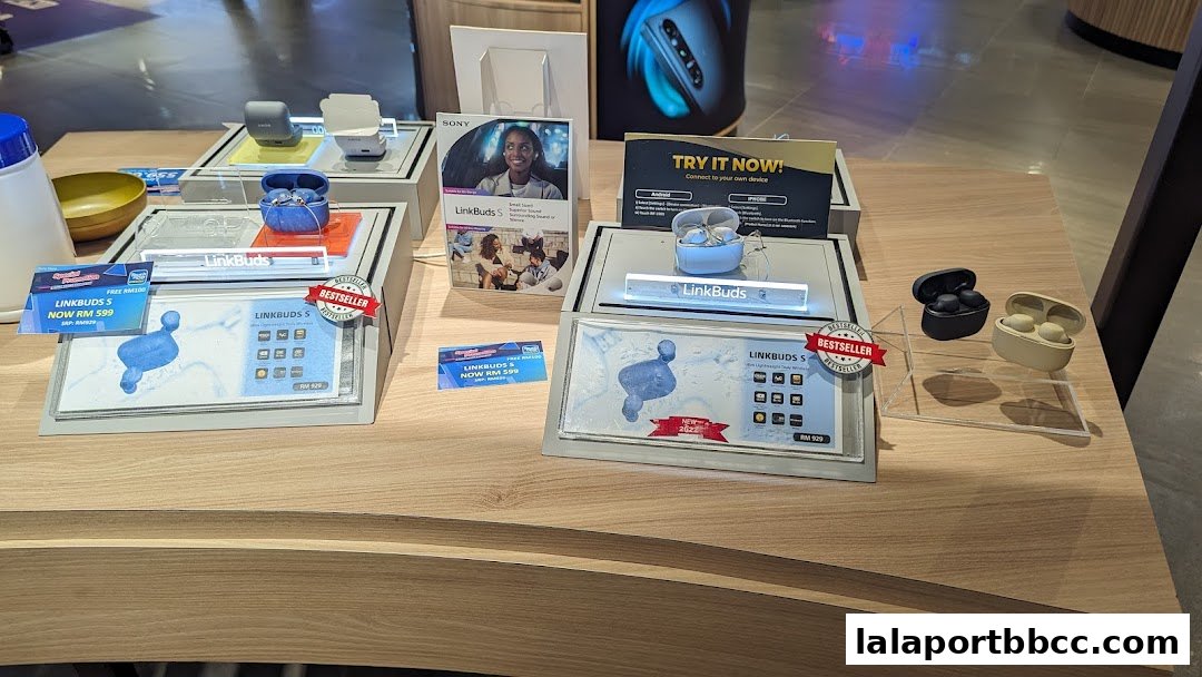 Sony LinkBuds S wireless earbuds displayed on a wooden counter with promotional materials.