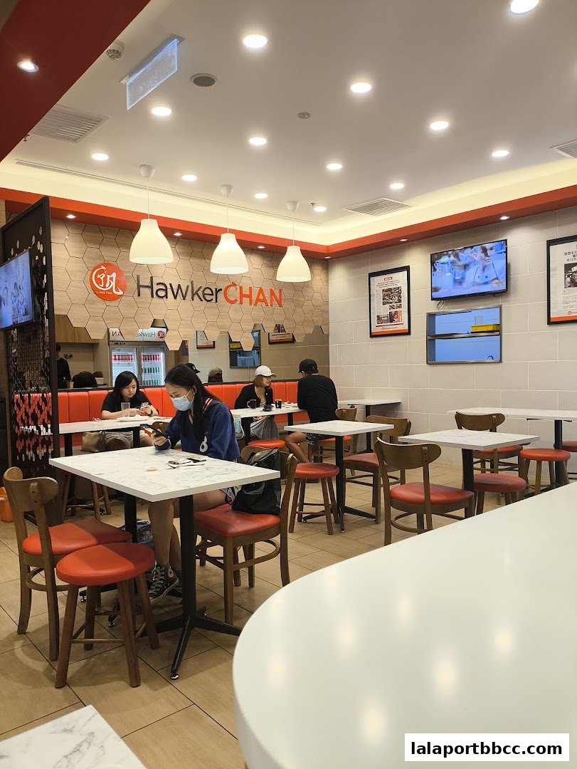 Interior view of Hawker Chan LaLaport BBCC with customers dining at tables.