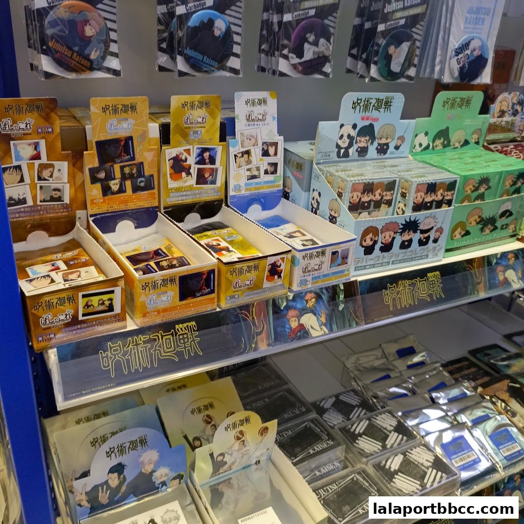 A display of Jujutsu Kaisen merchandise, including badges, cards, and straps.