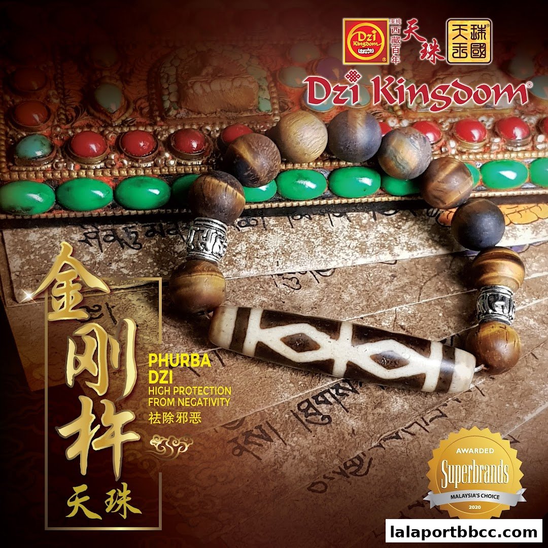 A Dzi Kingdom bracelet with tiger eye beads and a Phurba Dzi bead, presented with decorative elements.