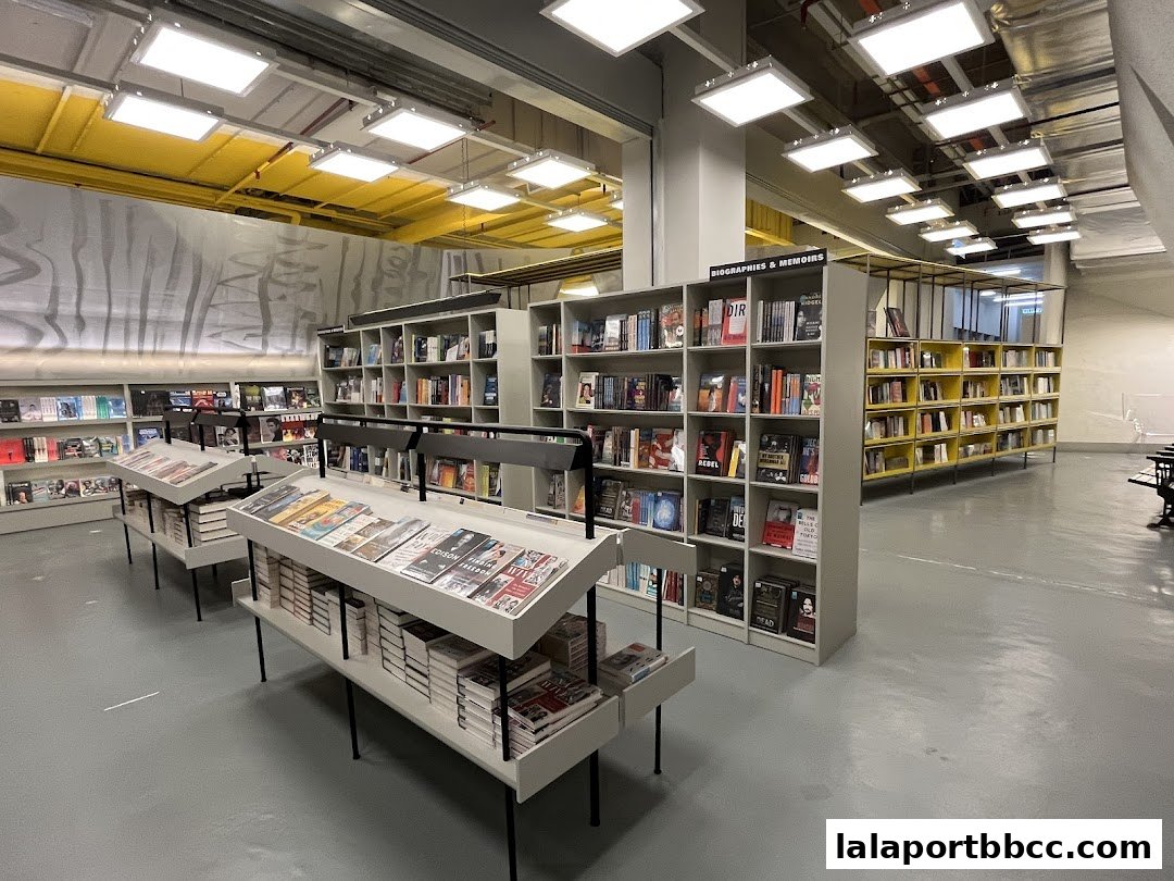 Interior view of a spacious bookstore with shelves full of books and display tables.