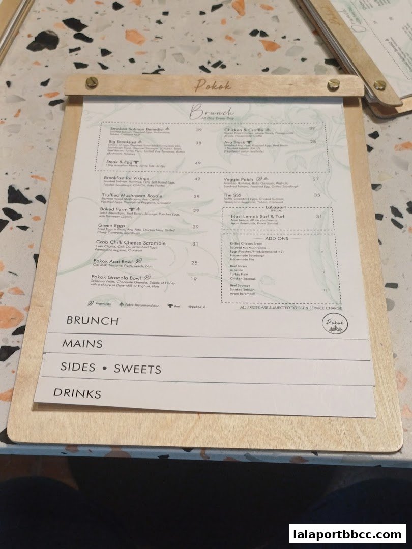 A menu from Pokok LaLaport featuring brunch items, mains, sides, sweets, and drinks.
