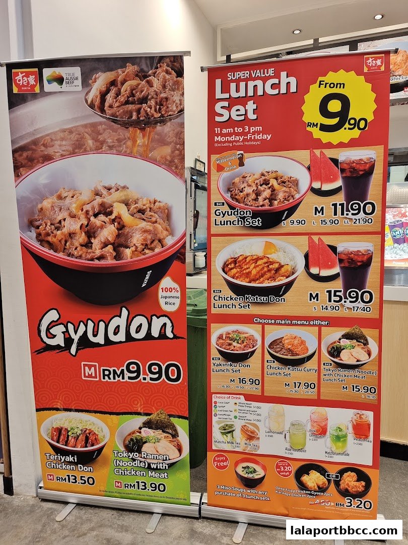 Roll-up banners displaying Sukiya's lunch sets, Gyudon, and other Japanese dishes with prices.