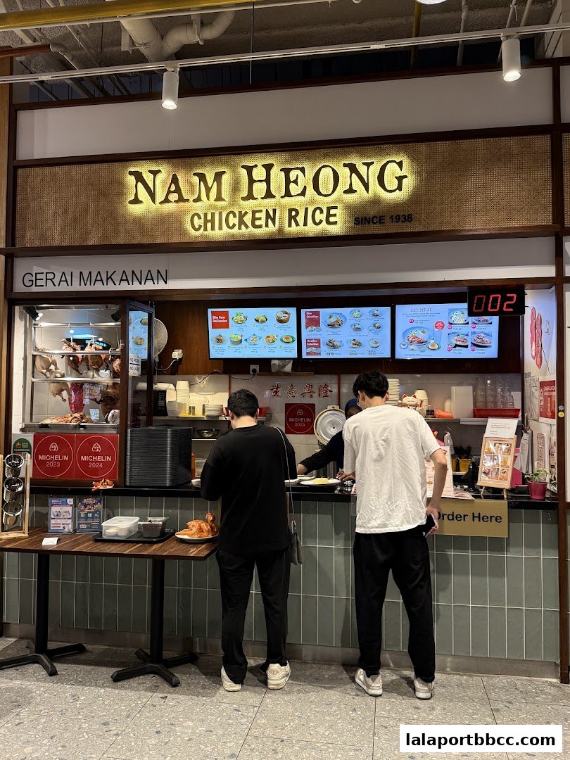 Nam Heong Chicken Rice shop with customers ordering at the counter.