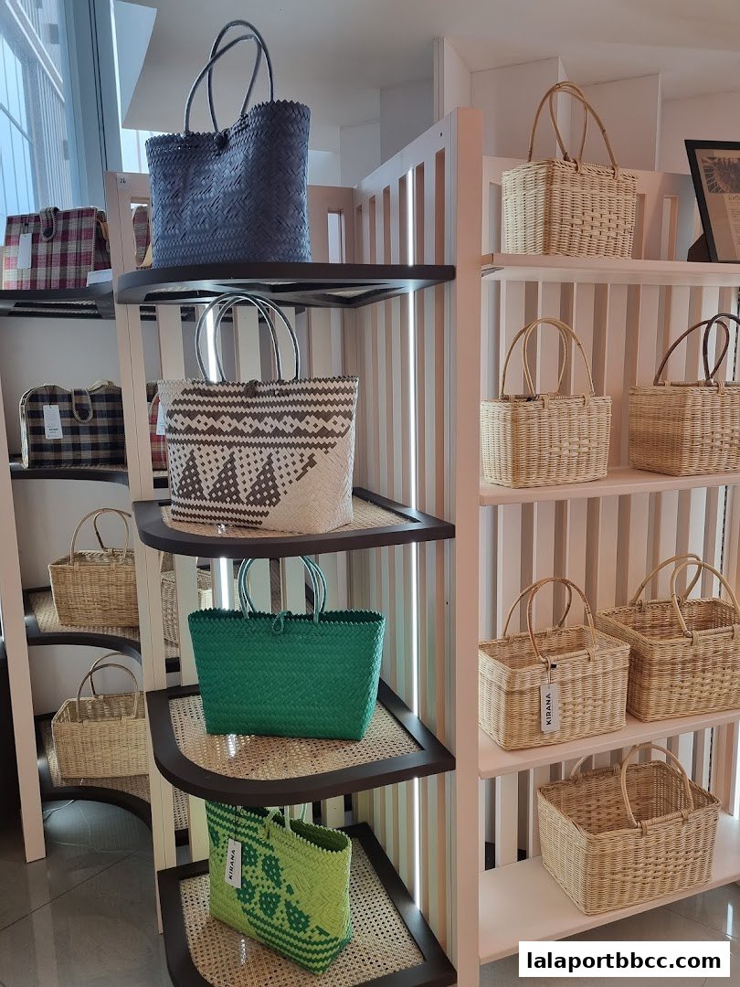 A display of various woven bags and baskets in different colors and styles.