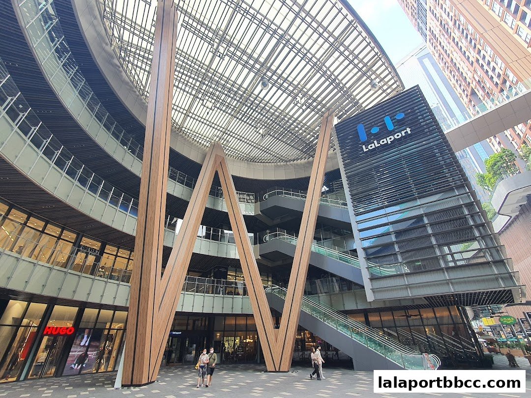 Interior view of Lalaport BBCC shopping mall with escalators and shops.