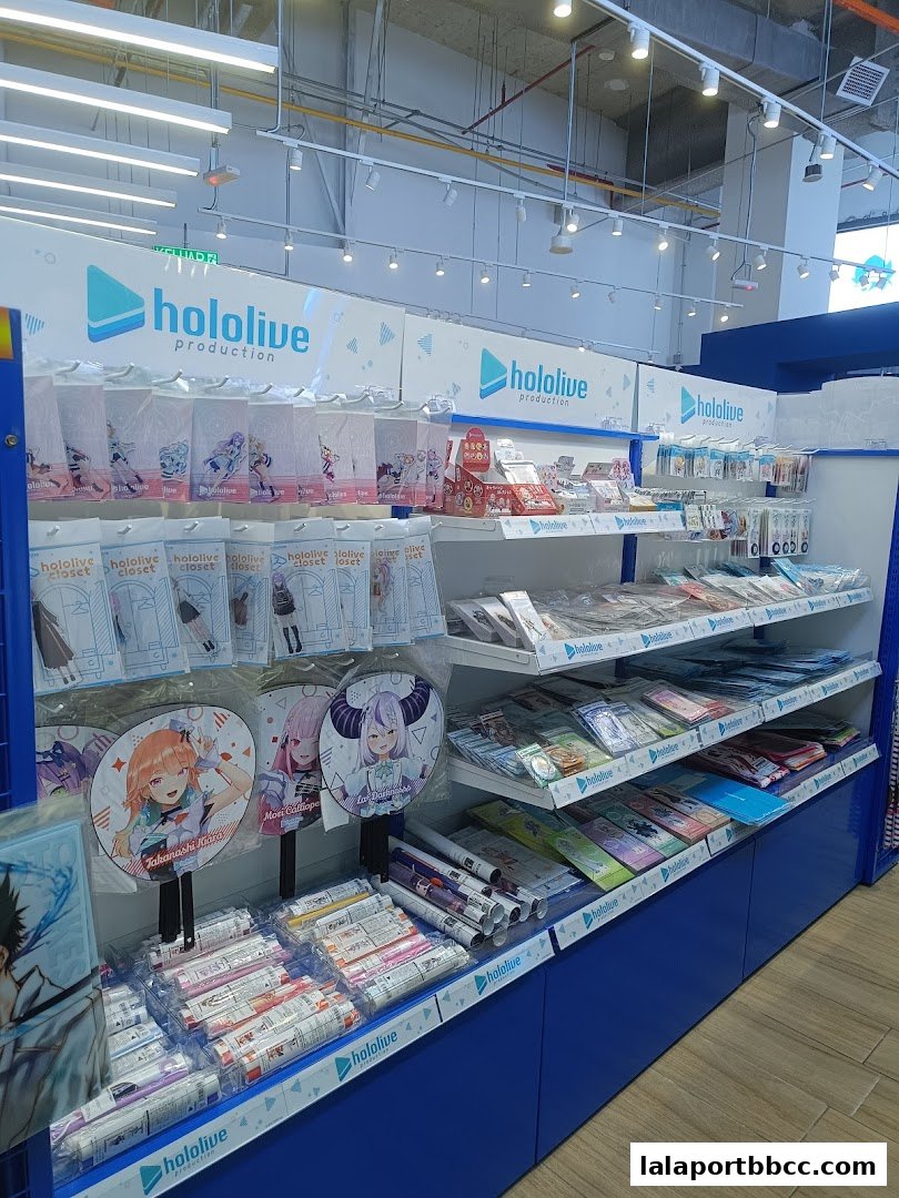 A retail display featuring merchandise from Hololive Production, including fans and rolled posters.