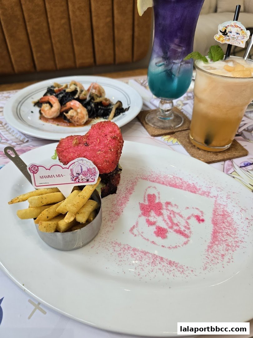 A plate of food with fries and a heart-shaped item, next to two colorful drinks.