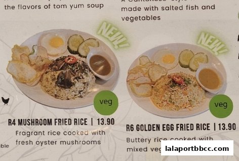 Two plates of fried rice dishes, one with mushrooms and the other with golden egg, both served with fried egg and chips.