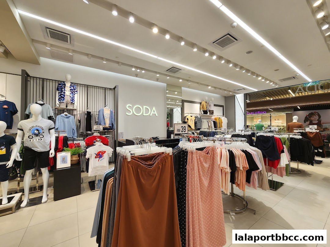 Interior view of a SODA clothing store showcasing apparel on mannequins and racks.