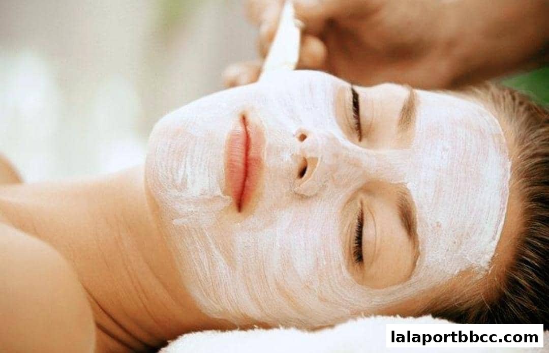 A person receiving a facial treatment with a white mask applied to their face.