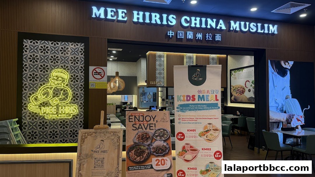 The entrance of Mee Hiris China Muslim restaurant with signage and promotional posters.