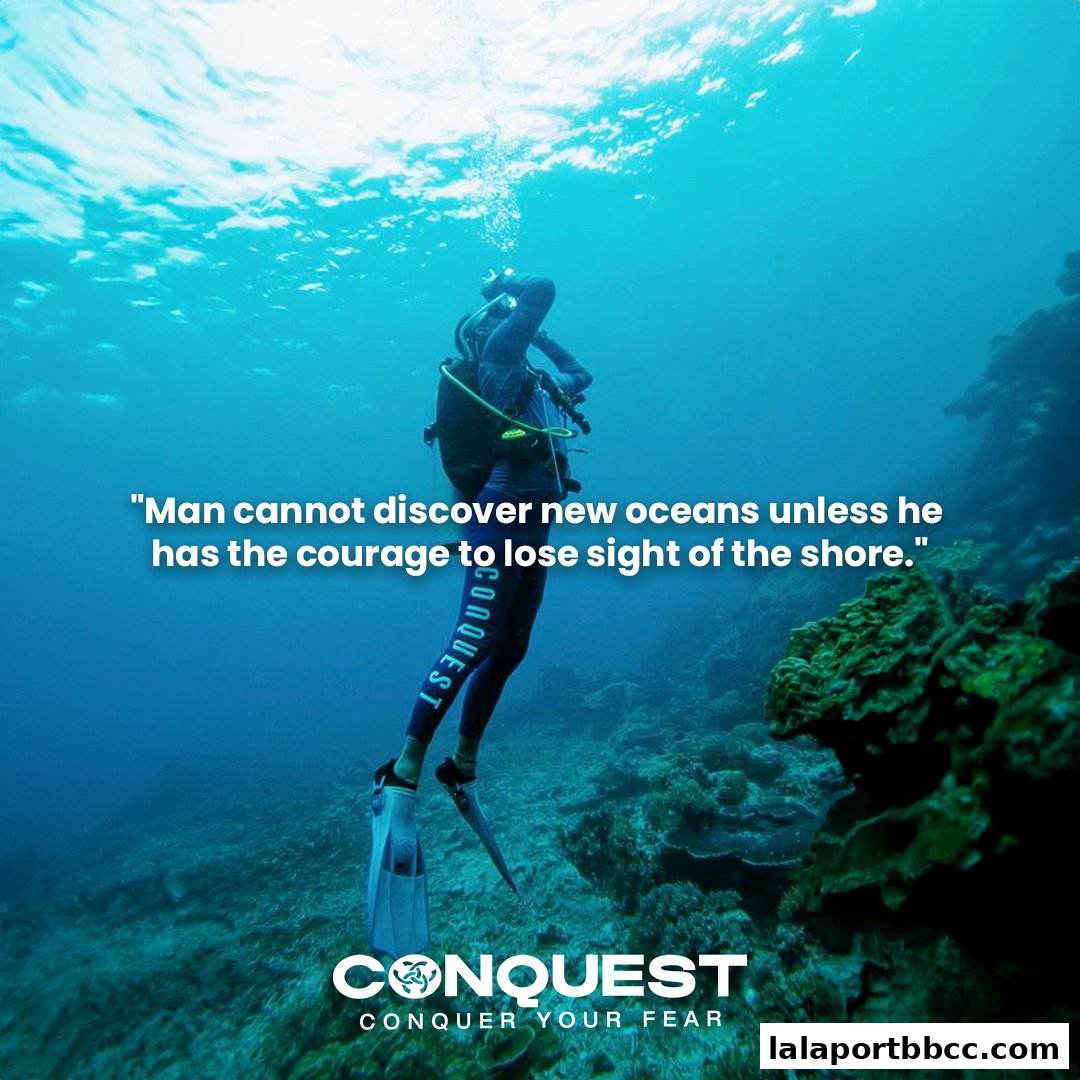 A diver explores the ocean floor with a motivational quote about courage.