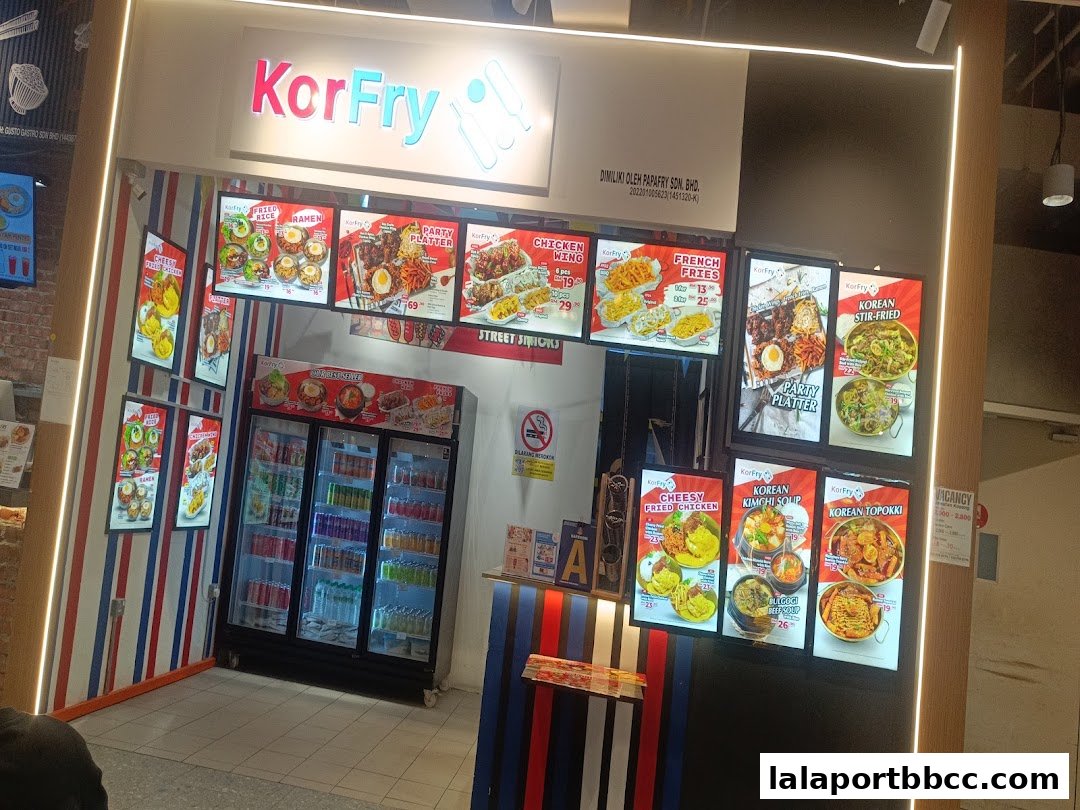 The KorFry shop front displays illuminated menus of Korean street food and drinks.