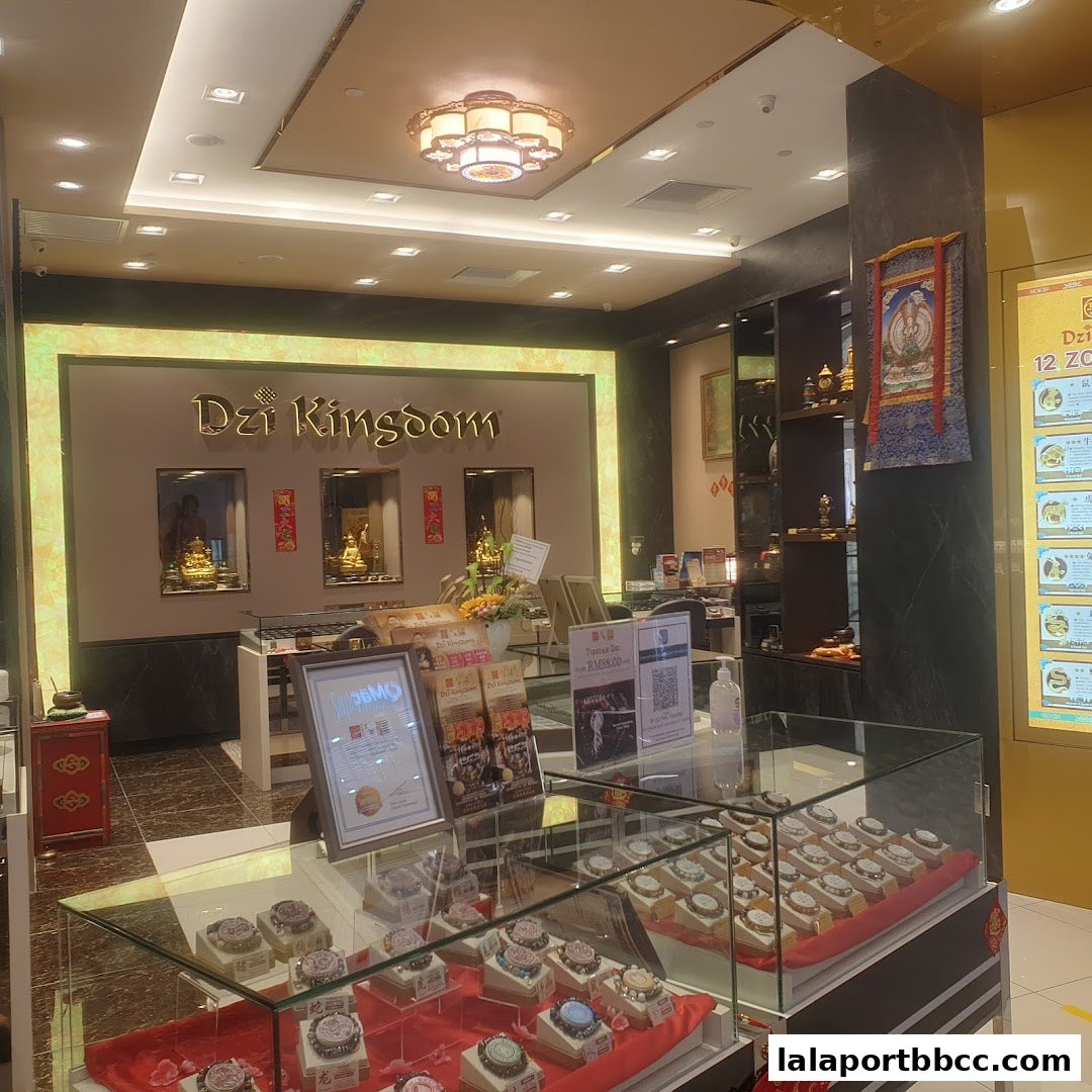 Interior of Dzi Kingdom shop showcasing display cases with Tibetan Dzi beads and Buddhist artifacts.
