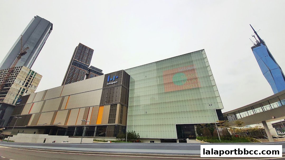 Exterior view of LaLaport BBCC shopping mall with surrounding skyscrapers and a skybridge.