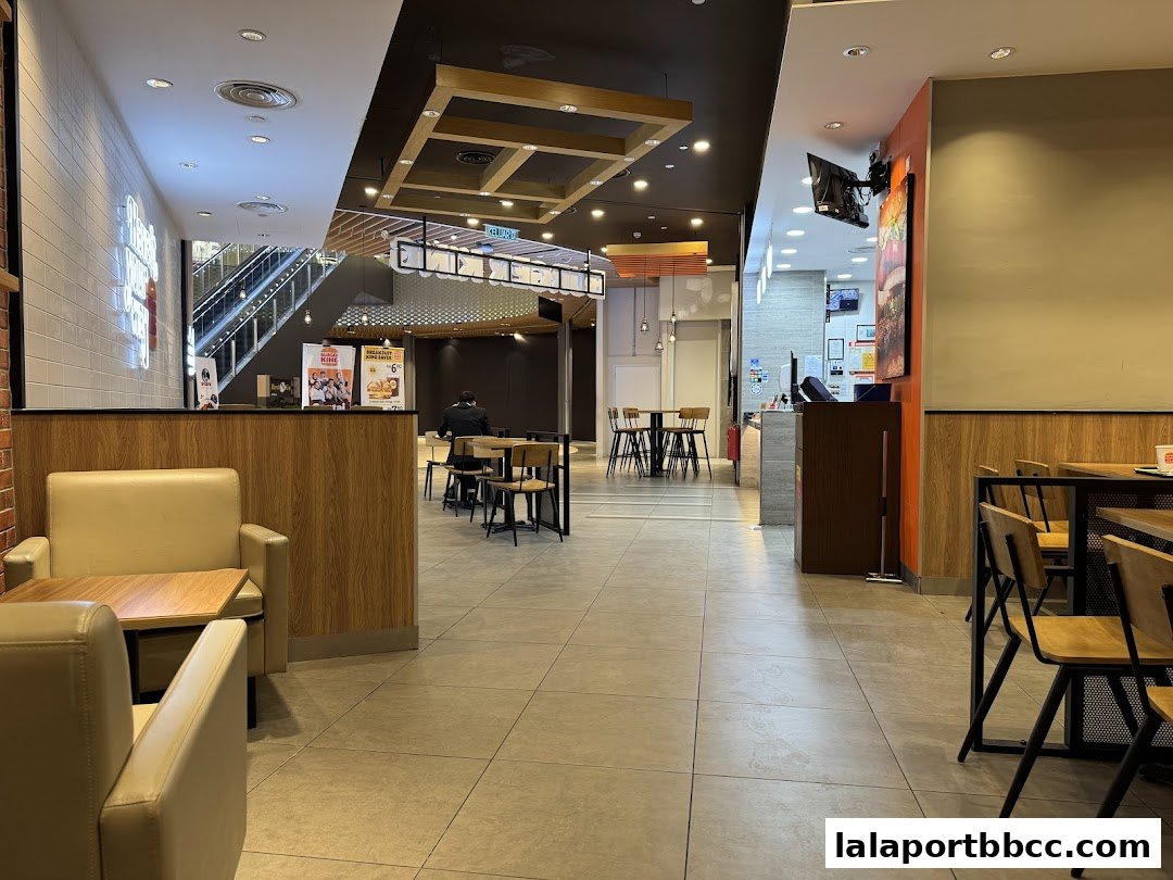 Interior view of a Burger King restaurant with seating areas and a counter.