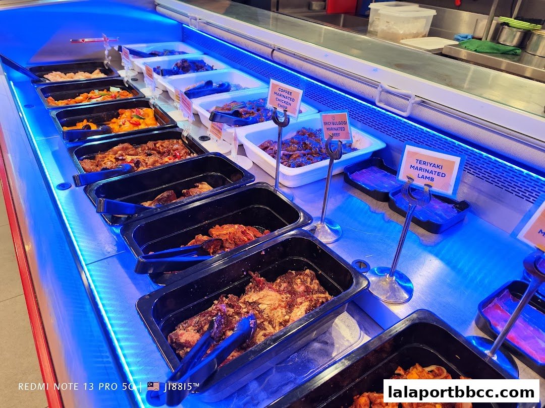 A display of marinated meats in a refrigerated case with blue lighting.