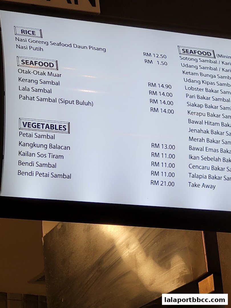 A digital menu displaying various rice, seafood, and vegetable dishes with prices.