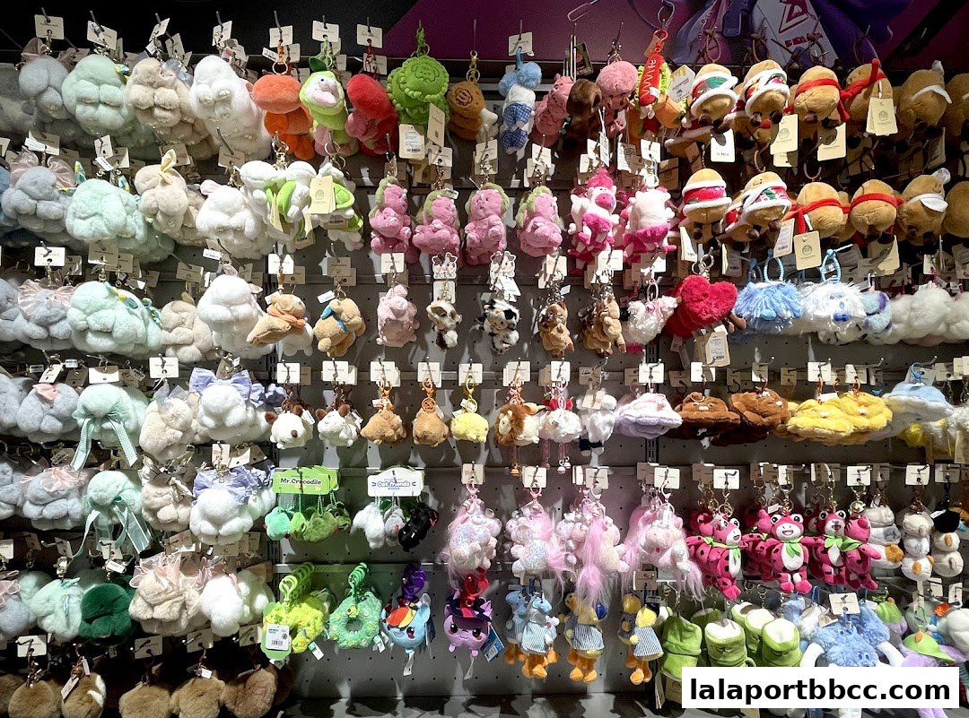 A wall display filled with a wide variety of colorful and fluffy plush keychains.