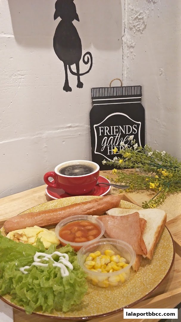 A hearty breakfast platter with coffee, sausage, scrambled eggs, beans, corn, and toast.