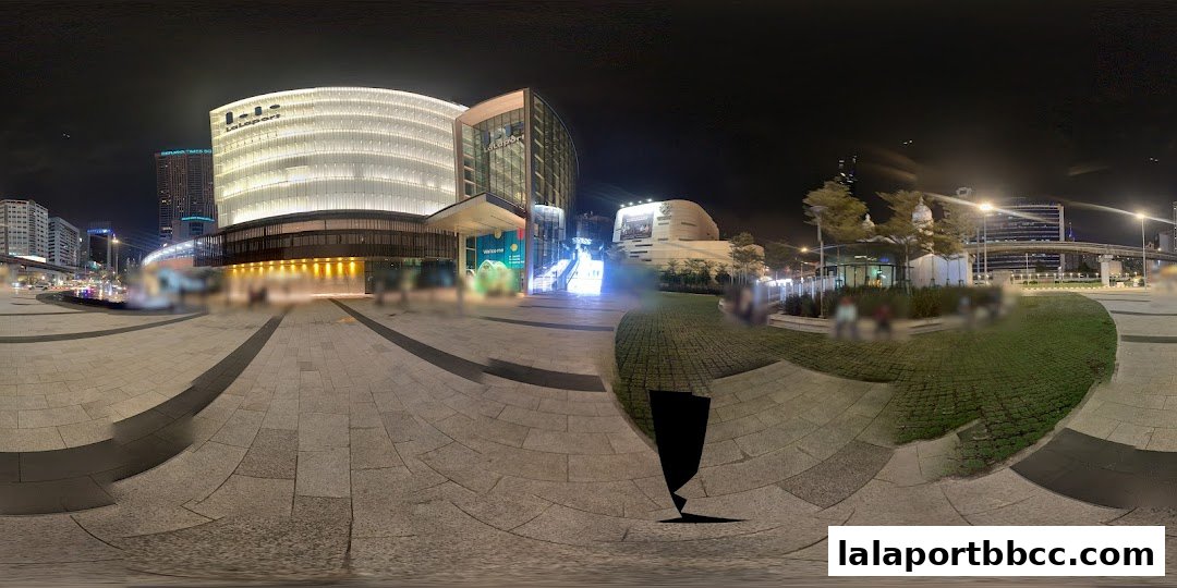 Exterior view of LaLaport BBCC shopping mall at night with illuminated facade and surrounding plaza.