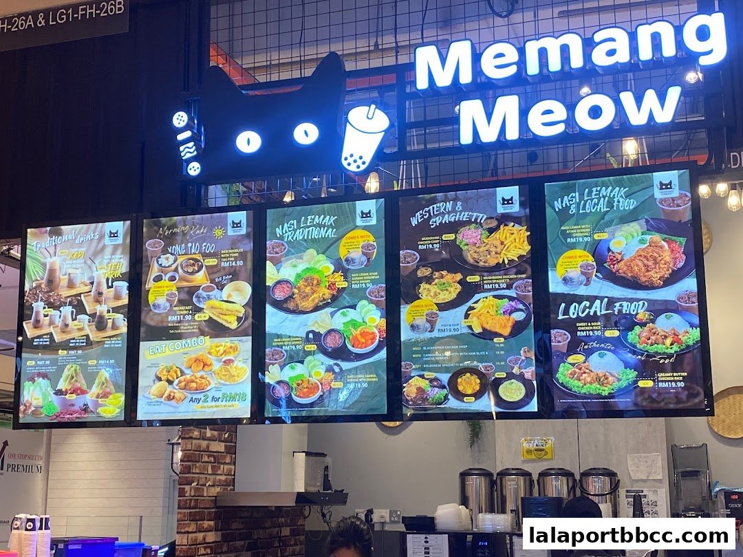 Digital menu boards displaying various food and drink options at Memang Meow.