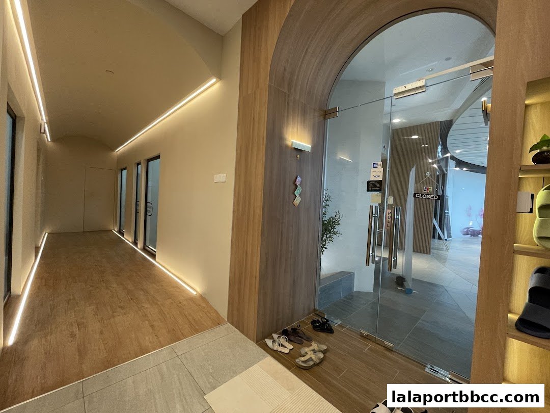 Modern dental clinic entrance with glass doors and a well-lit hallway.
