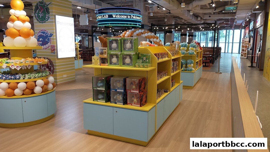 Interior of a brightly lit Pokemon store with merchandise displays and seating areas.