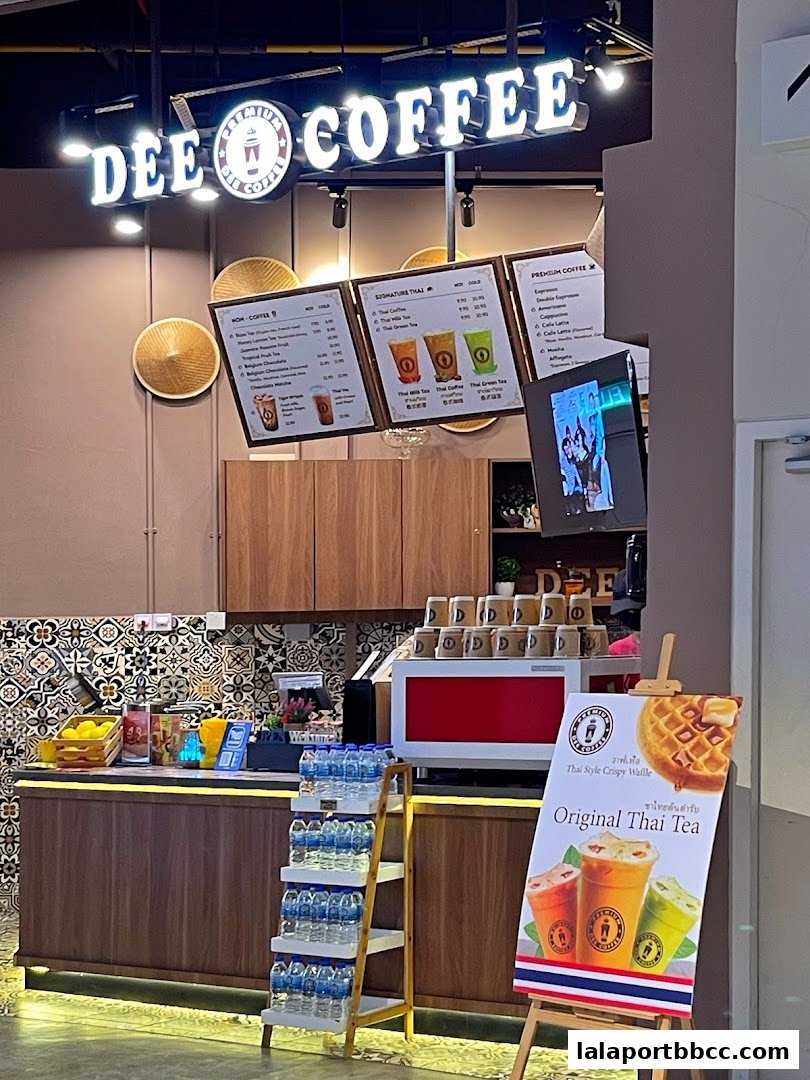 The exterior of Dee Coffee Malaysia shop with menus and promotional signage.