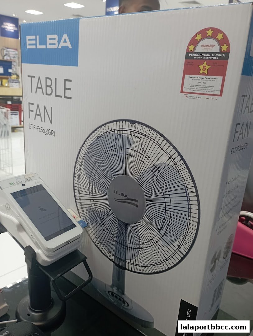A box for an Elba table fan is displayed with a payment terminal in front of it.
