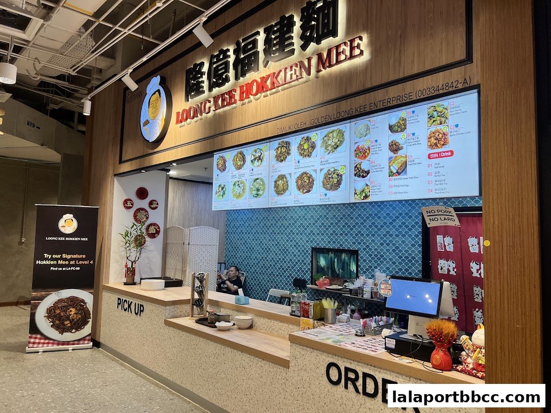 The Loong Kee Hokkien Mee shop counter with a digital menu and ordering station.