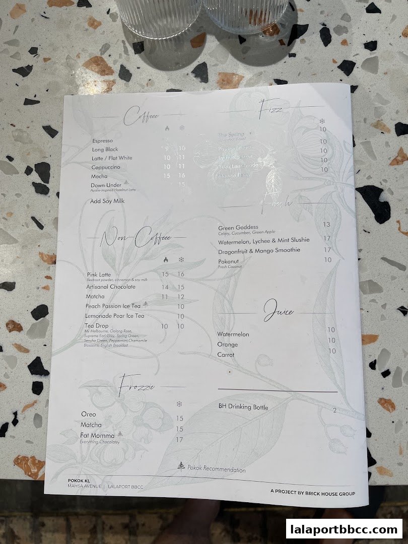 A menu from POKOK KL featuring coffee, non-coffee drinks, fizz, juice, and frozzie options.