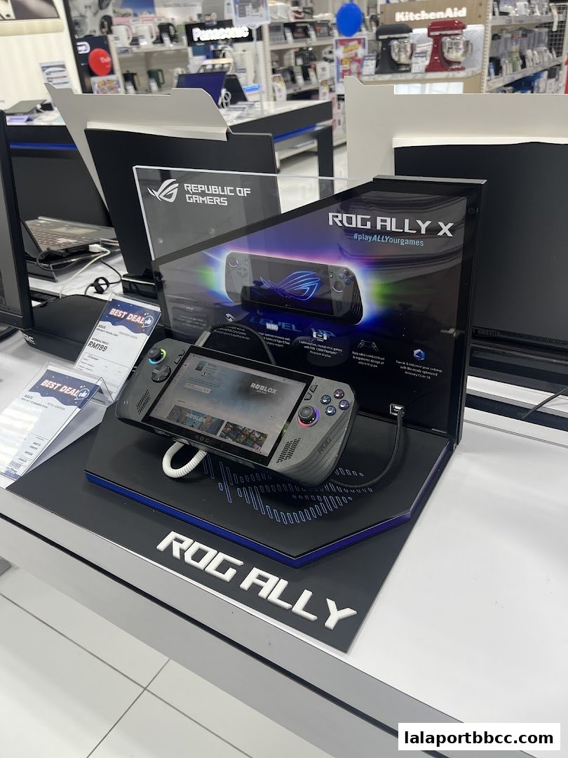 A display of the ROG Ally X gaming handheld device in a retail electronics store.