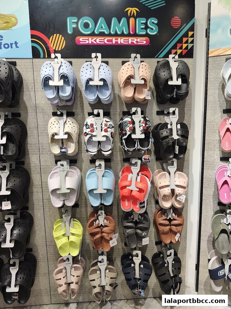 A wall display of Skechers Foamies sandals in various colors and styles.