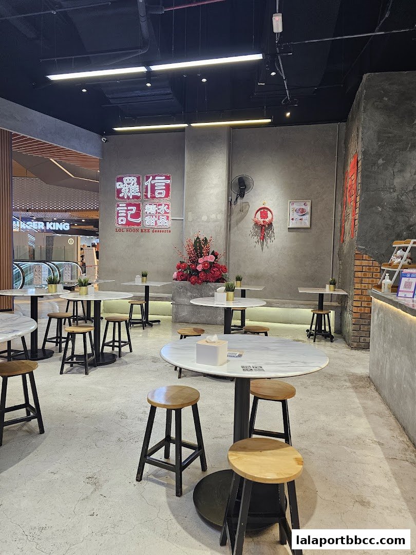 Interior of Lol Soon Kee Desserts with tables, chairs, and shop signage.
