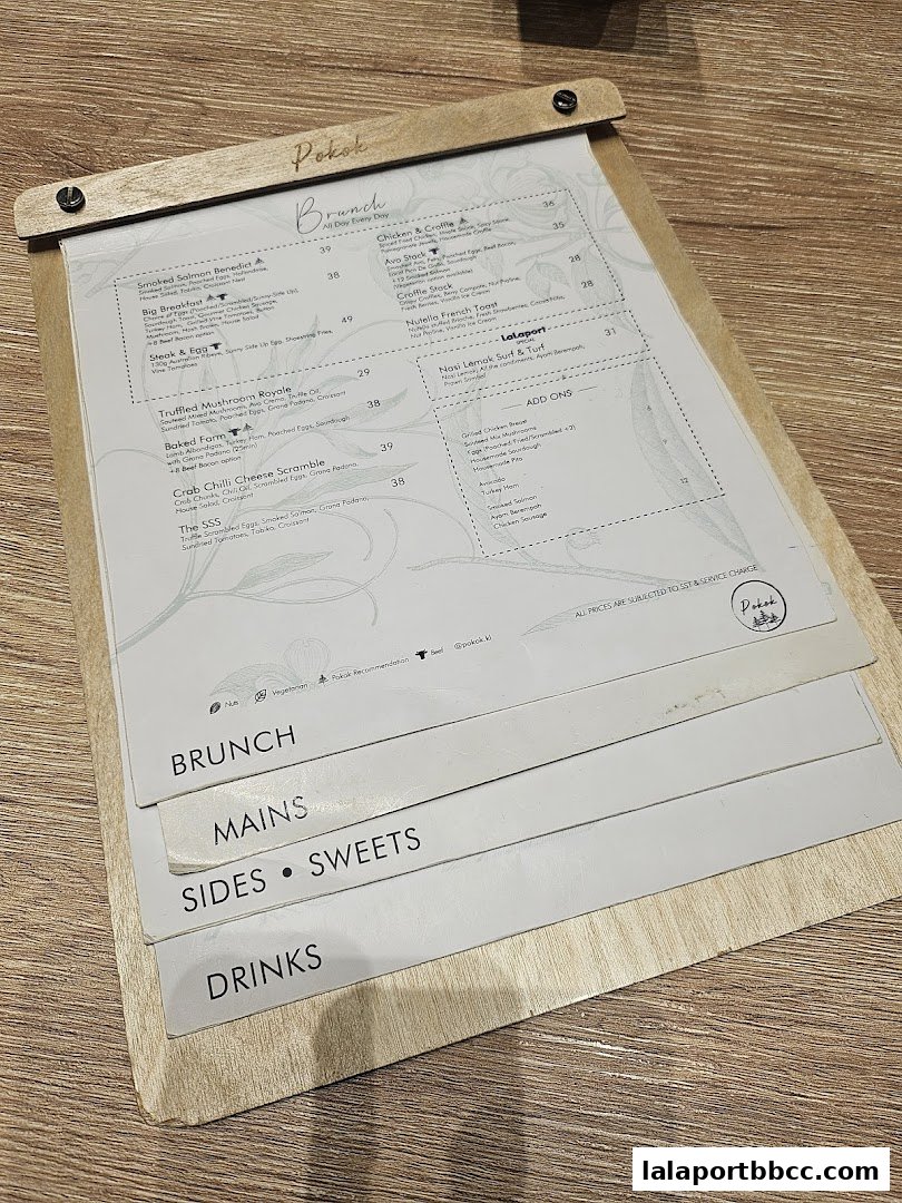 A menu from POKOK LaLaport featuring brunch items, mains, sides, sweets, and drinks.