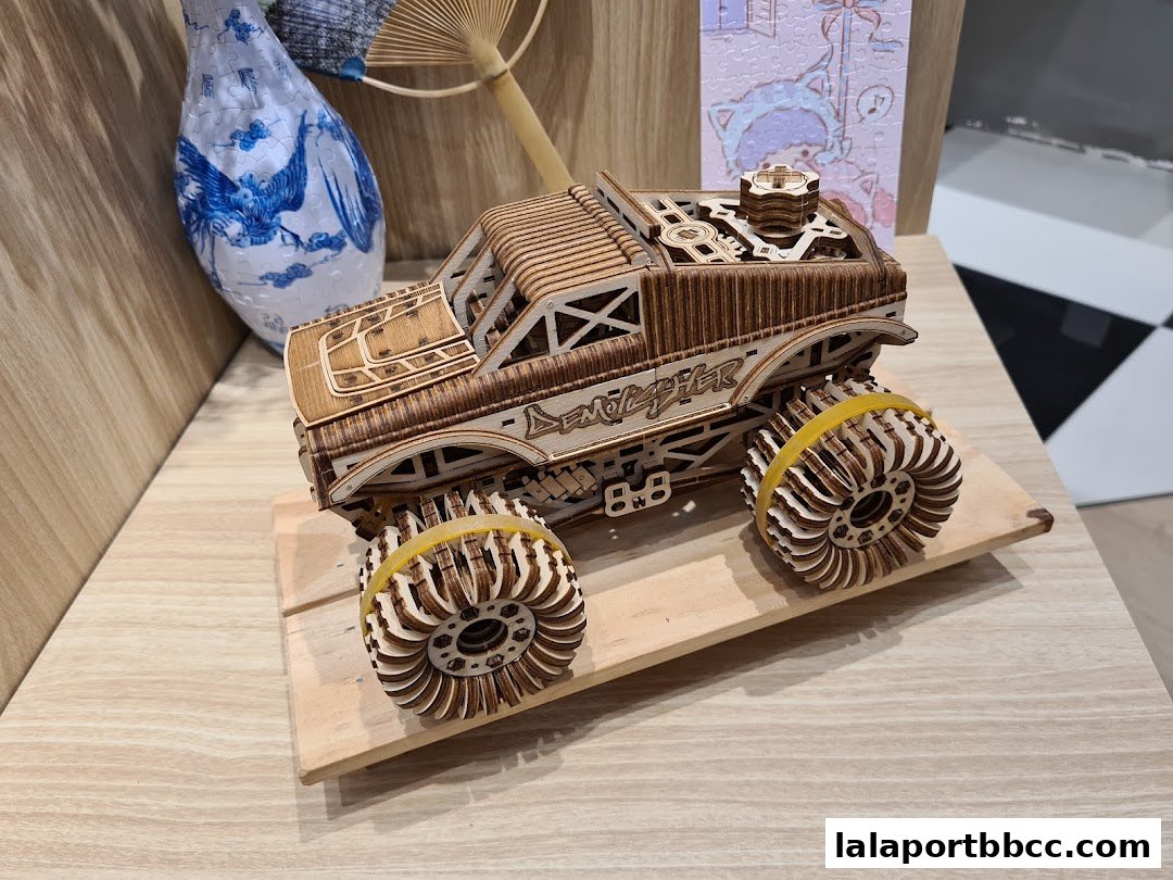 A detailed wooden model of a monster truck with intricate laser-cut details.