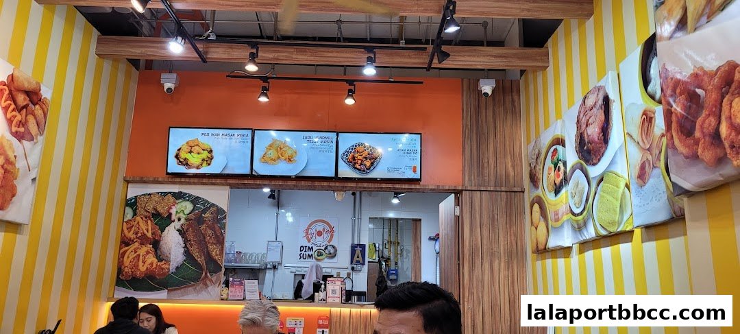 Interior view of a restaurant with food displays and menu screens.