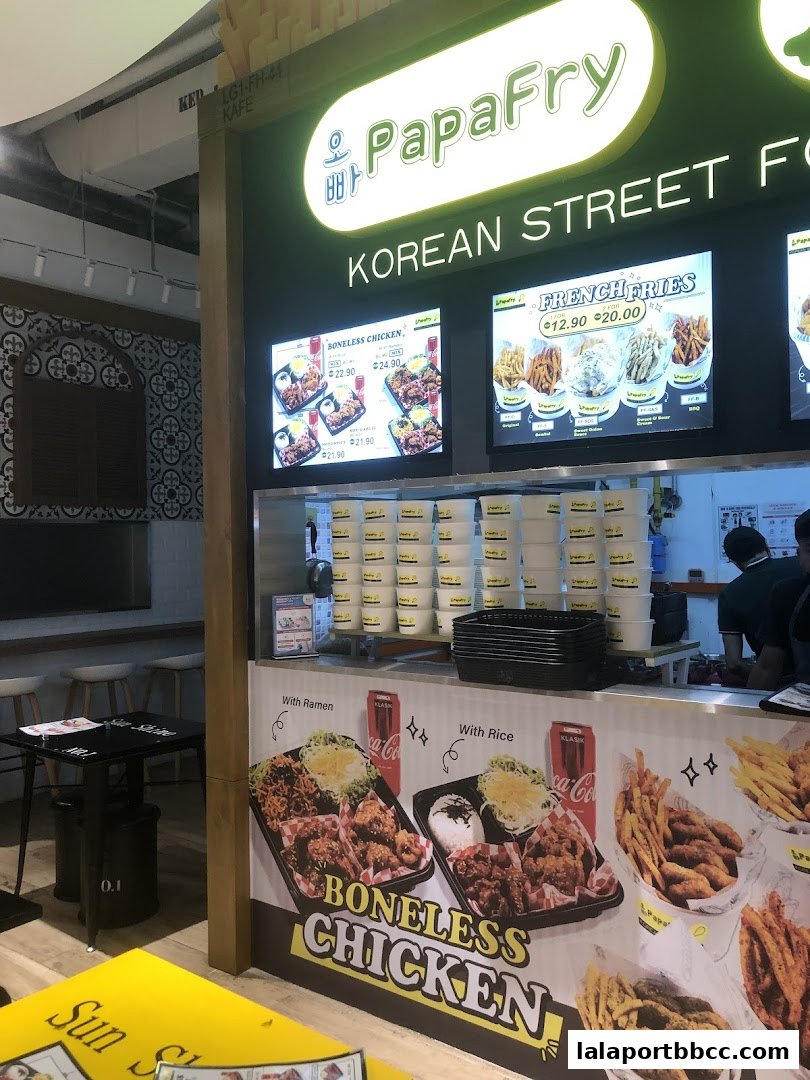 PapaFry Korean Street Food stall with digital menus displaying boneless chicken and french fries.
