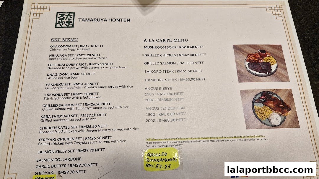 A menu from Tamaruya Honten Steakhouse featuring set and a la carte options.