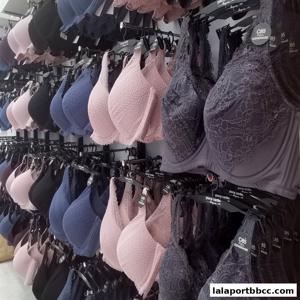 A display of various bras in different colors and styles, neatly arranged on racks.