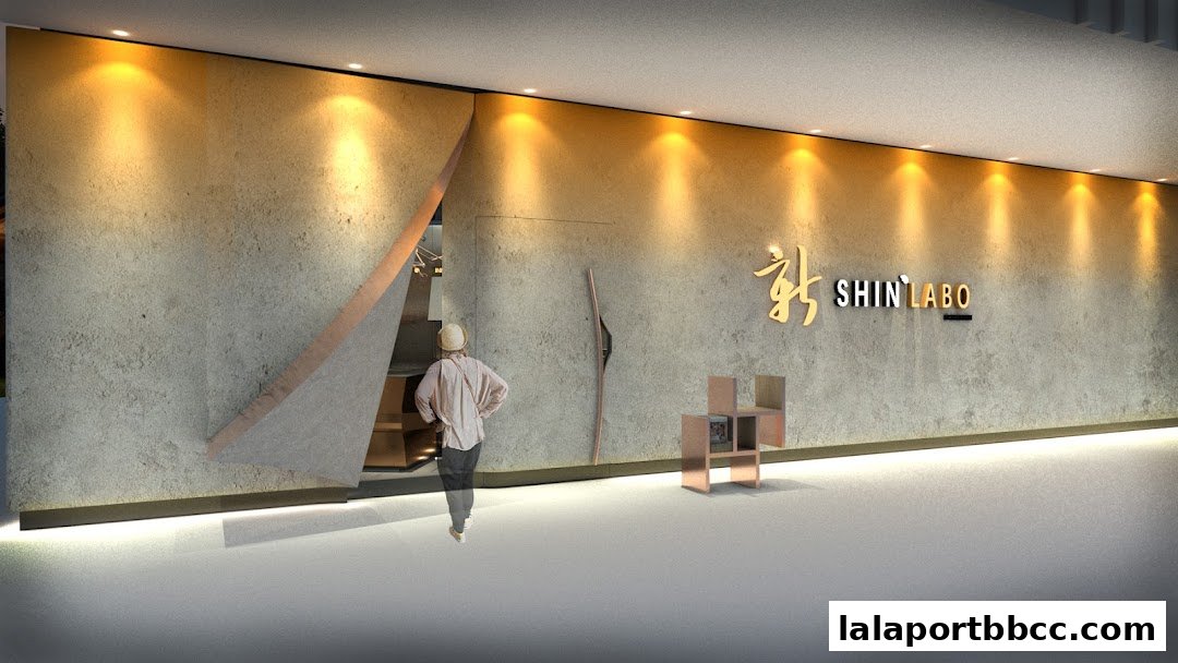 A person enters a modern shop with a textured wall and illuminated signage.