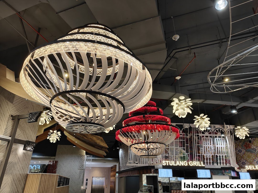 Interior view of a dining area with large, decorative pendant lights and signage.