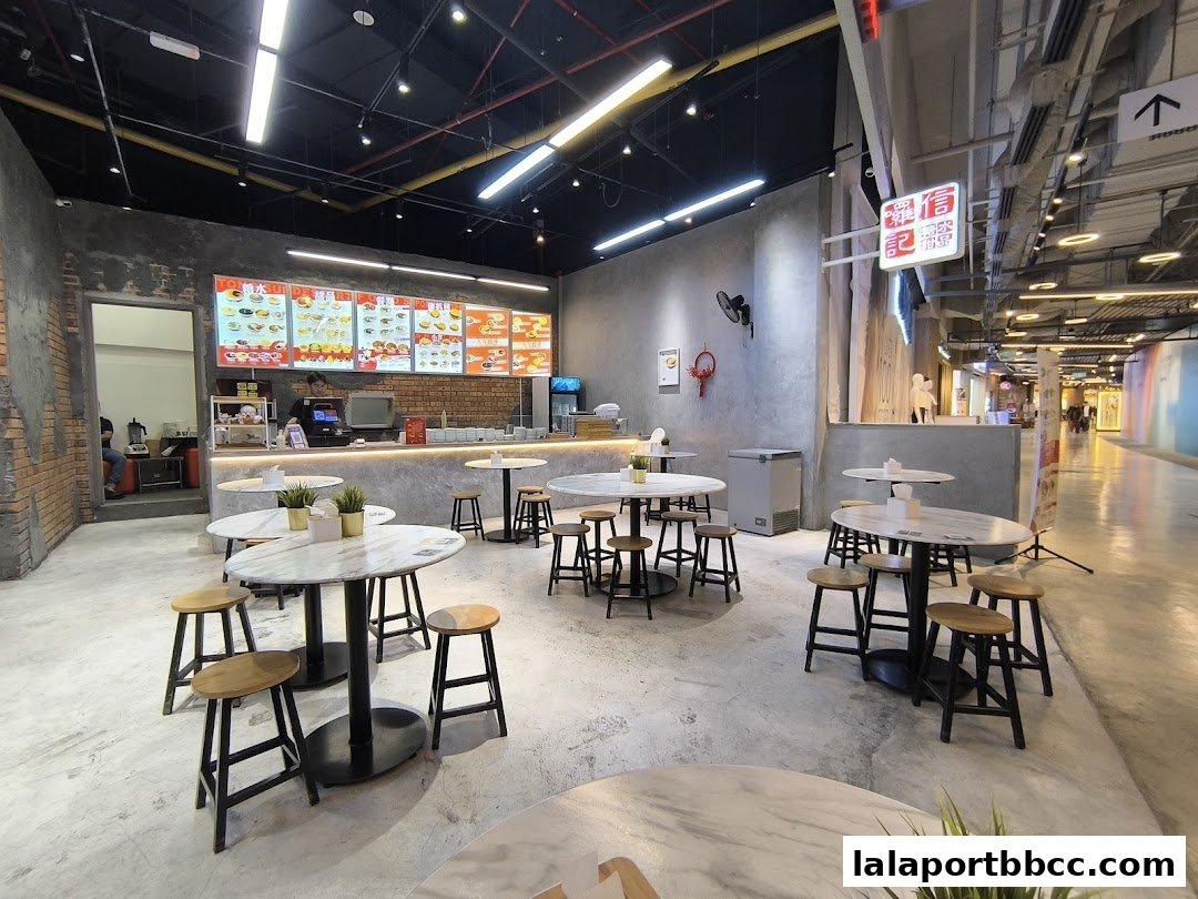 Interior view of Lol Soon Kee Desserts Lalaport with seating and a counter display.