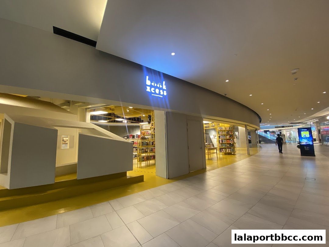 The entrance of BookXcess LaLaport, a brightly lit bookstore with shelves of books visible.