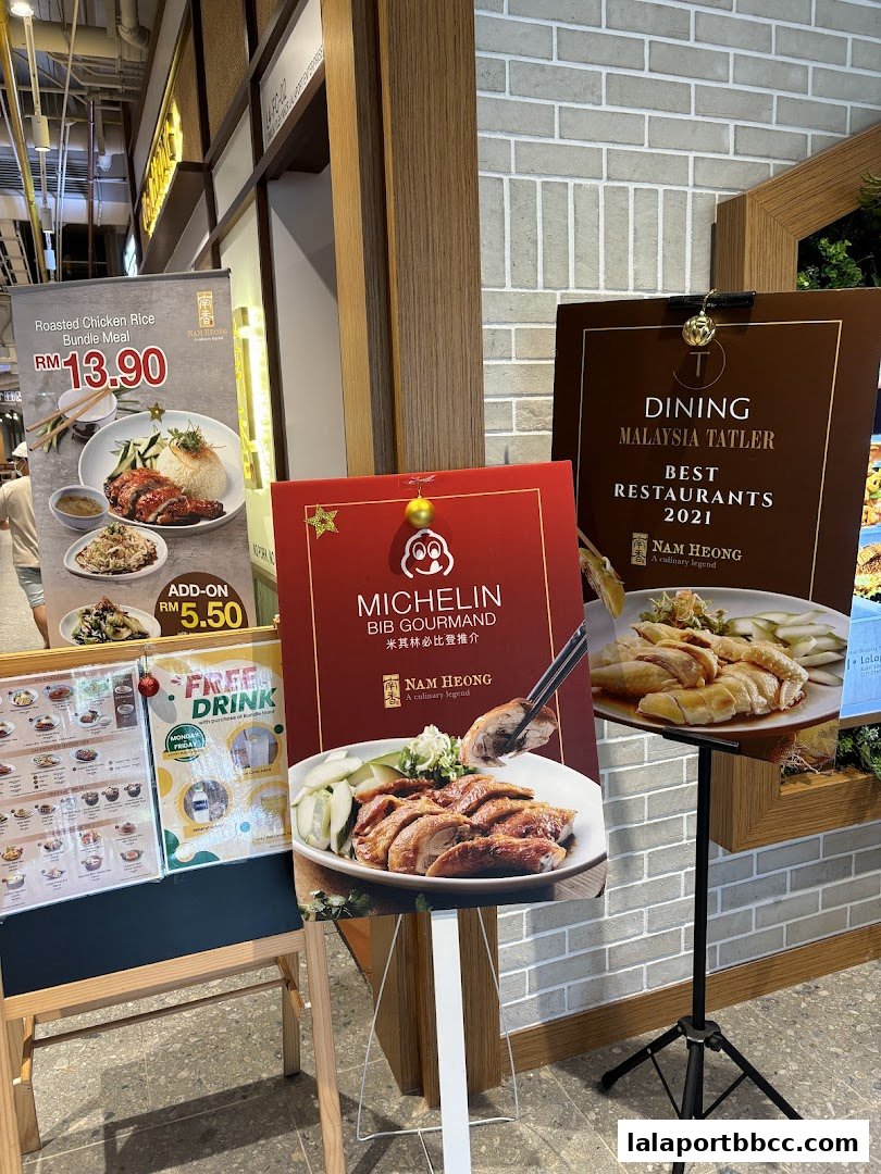 Nam Heong Chicken Rice shop front with promotional posters and awards.