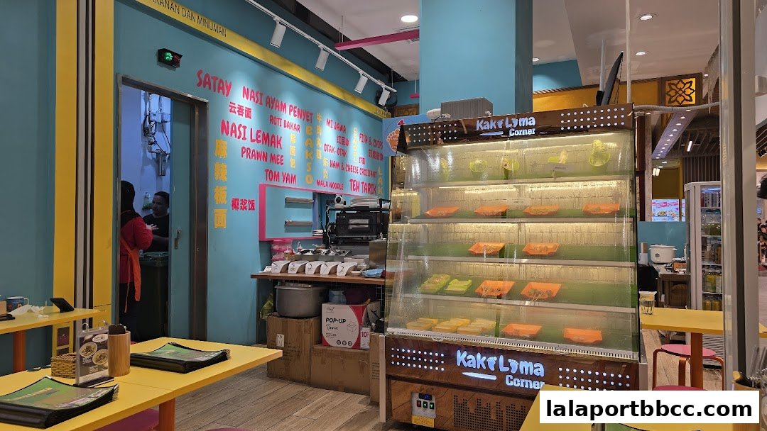Interior of Kaki Lima Corner with a display fridge and menu items on the wall.
