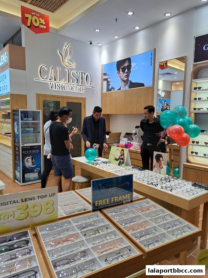 Interior of Calisto Vision Care with displays of eyeglasses and staff assisting customers.